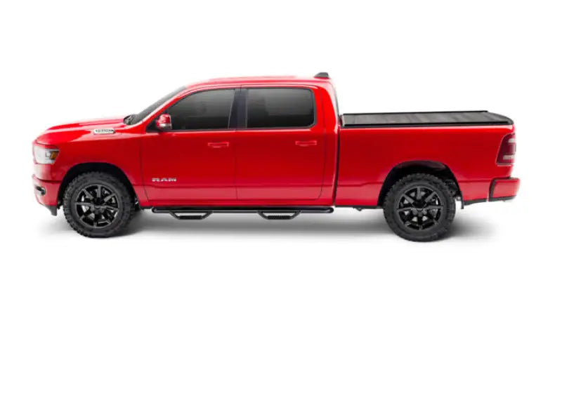 Red four-door pickup truck with black matte Tonneau Cover Manual Retractable and Trax Rail system
