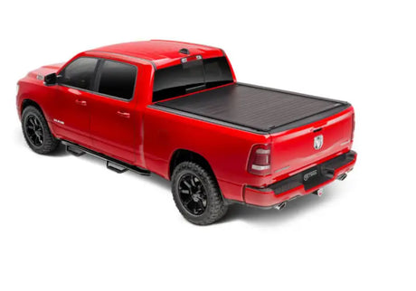 Red pickup truck with black matte manual retractable tonneau cover and trax rail system
