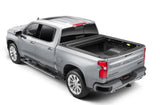 Silver Chevrolet Silverado pickup with a matte black power retractable tonneau cover