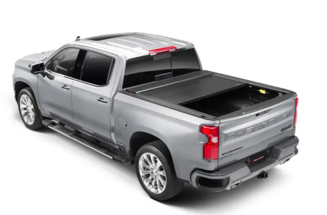 Silver pickup truck with matte black tonneau cover power retractable and lockable