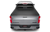 Silver pickup truck with power retractable tonneau cover in matte black finish