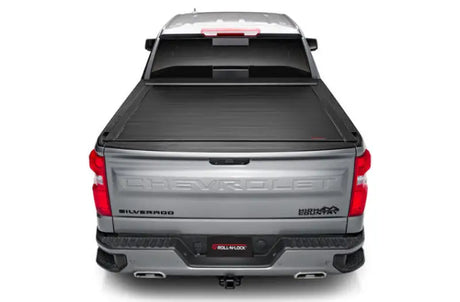 Silver pickup truck with power retractable tonneau cover in matte black finish