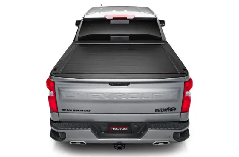Silver pickup truck with power retractable tonneau cover in matte black finish