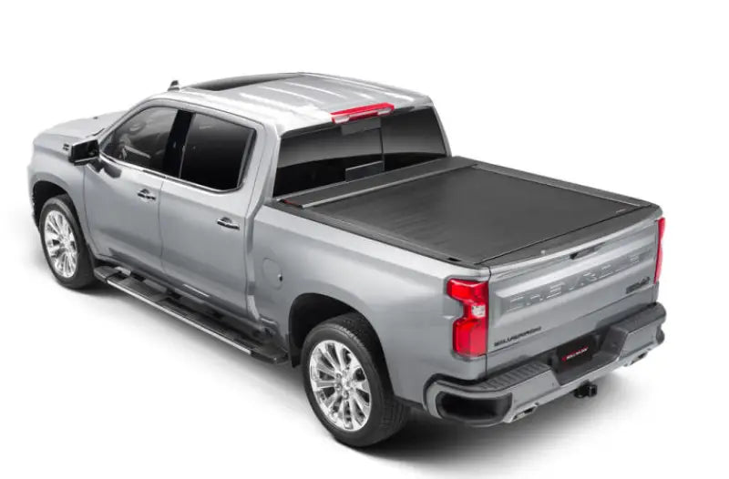 Silver pickup truck with matte black tonneau cover power retractable and lockable tips
