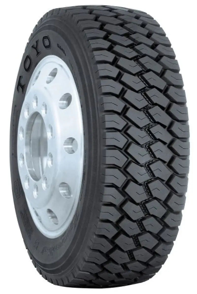 Truck tire with aggressive tread showing Toyo M608Z 70R195 140L model for off-road grip