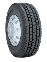 Truck tire with a silver rim showcasing the Toyo M647 tire model