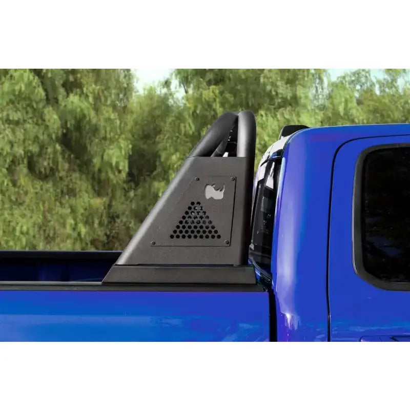 Blue pickup truck with black bed bar and roll bar mounted on open channel bed rail