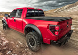 Red Ford Raptor pickup truck with Truxedo 2023 GMC Canyon bed cover on bed cover