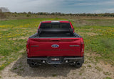 Red Ford F-150 Raptor with open bed cover showcasing Truxedo Sentry tonneau cover in vinyl fabric