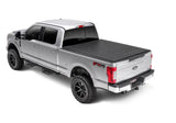 Silver Ford F-series pickup with black Sentry tonneau cover and side steps in bed cover photo