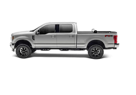 Silver Ford F-series pickup with Sentry tonneau cover and custom wheels on bed cover