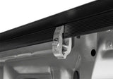 Silver metal clamp on black truck bed rail for Truxedo Sentry tonneau cover