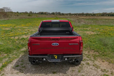 Red Ford Raptor with open bed cover featuring Sentry tonneau cover in vinyl fabric