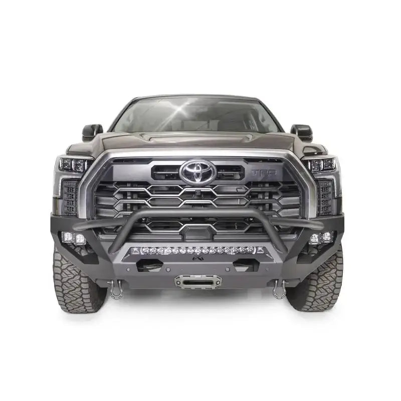 Front view of a Toyota truck equipped with the TT22-X5452-1 Fab Fours Matrix Bumper, showcasing rugged design and premium engineering, ideal for off-road protection and style enhancement.
