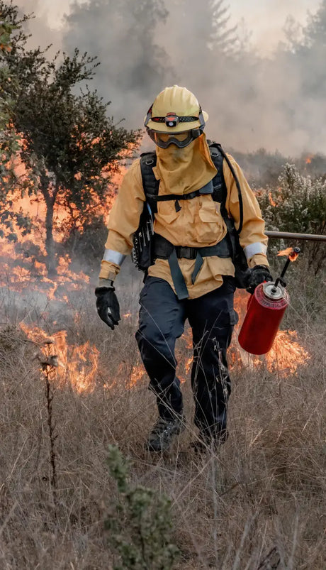 Firefighter with torch showcasing Twin Power 18 Inch Clear Coated Stainless Steel Hose