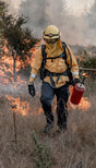 Firefighter with torch showcasing Twin Power 18 Inch Clear Coated Stainless Steel Hose