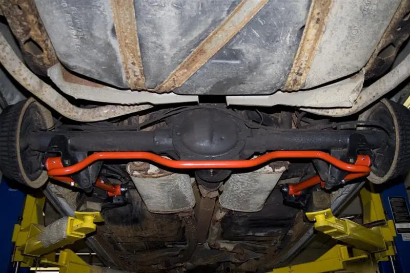 Orange sway bar under a car with UMI Performance 91-96 Impala SS adjustable extended length lower control arms