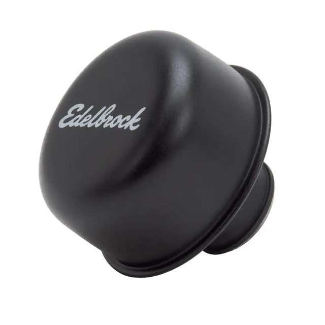 Black Edelbrock carburetor float bowl on valve cover breather for engine performance