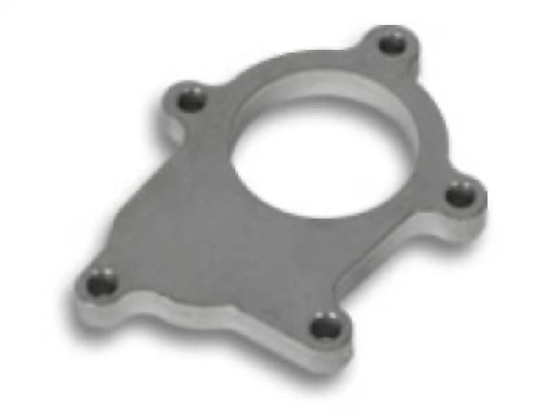 Metal adapter plate with bolt holes.