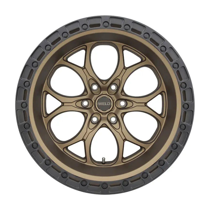 Bronze-colored wheel with a dark gray rim.