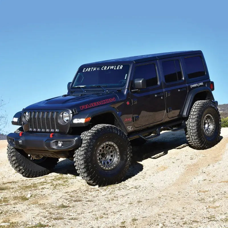Westin 18-22 Jeep Wrangler JL Unlimited with Outlaw Nerf Step Bars, black textured finish, on off-road terrain.