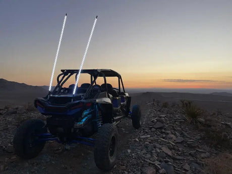 Blue off-road UTV with illuminated vertical whip lights from Whip It 5Ft Blk Bt Rgb Light Rod Set