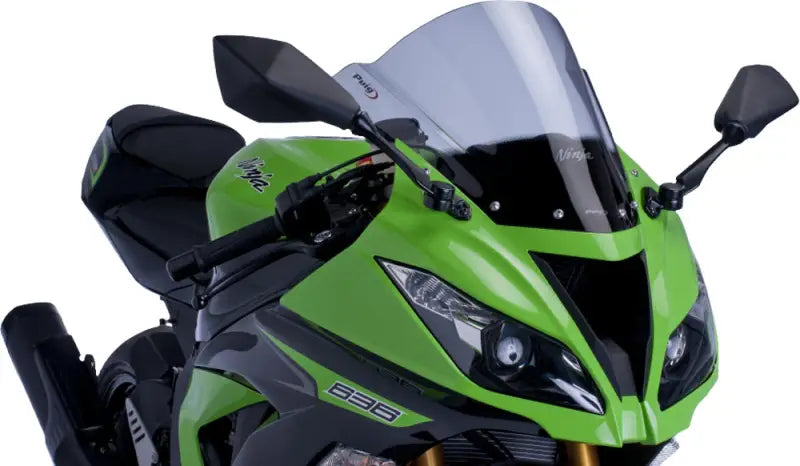 Green and black Kawasaki Ninja with tinted windscreen racing smoke for racing style