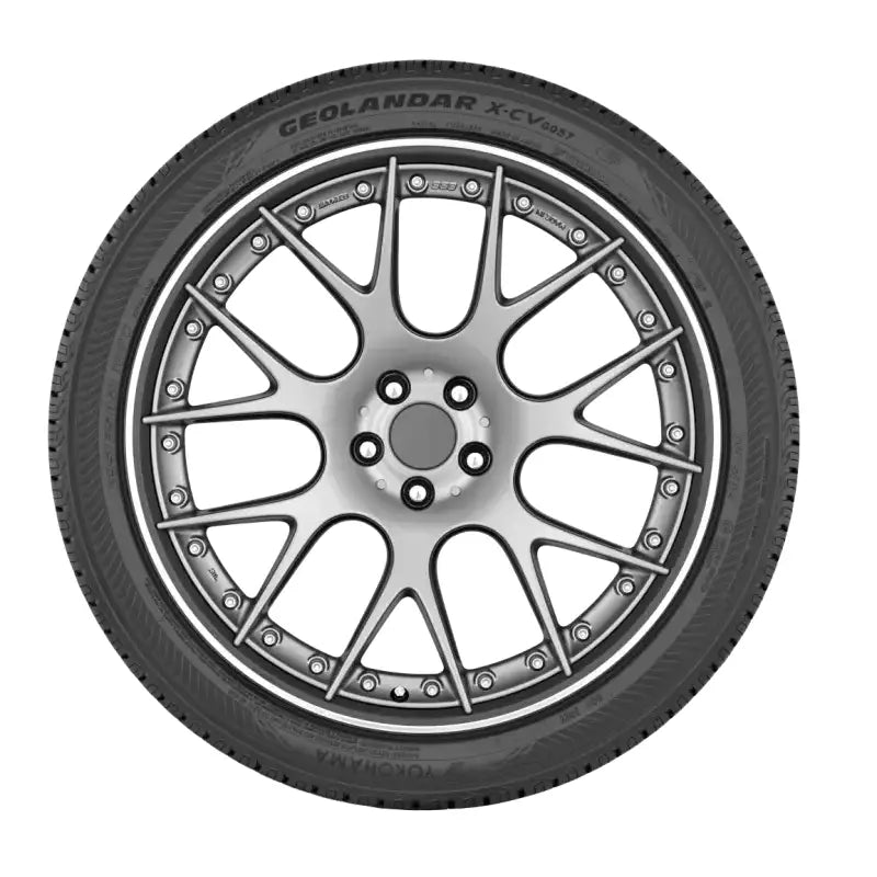 Car tire with decorative rim showing Yokohama Geolandar X-CV tire design
